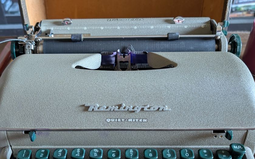 The Remington Quiet Riter, in its suitcase mount and cover on.